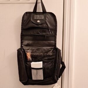 American Tourister Black Toiletry Bag with Durable Fabric and Clamshell Opening